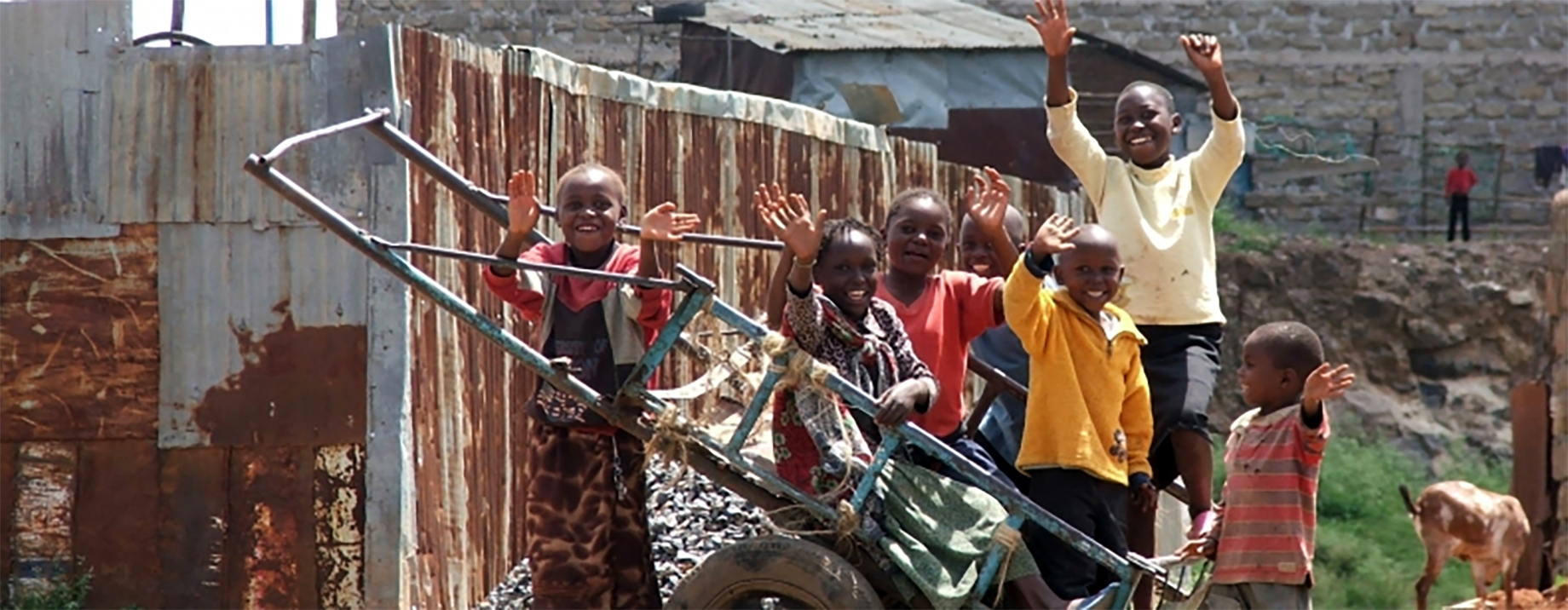 a group of young children, waving