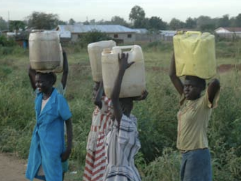 HTF Darfur – Population Council four adolescents holding jugs of water on their heads