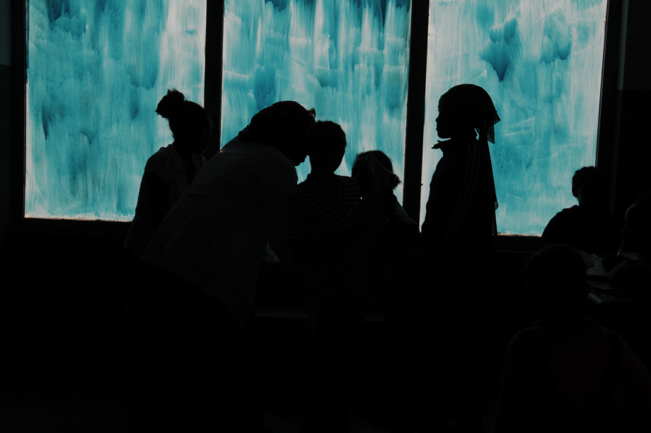 silhouette of children in front of a window Ideas. Evidence. Impact.