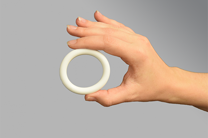 a hand holding up the Nestorone-only vaginal ring Ideas. Evidence. Impact.