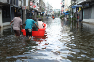 people in a boat on a flooded street