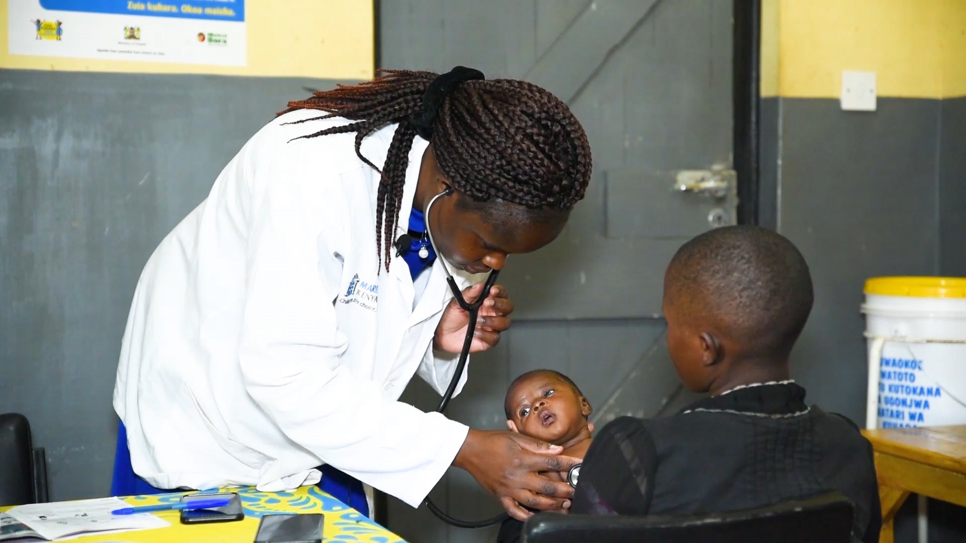 Doc_Baby4 – Population Council A healthcare worker examining an infant in their mother's arms